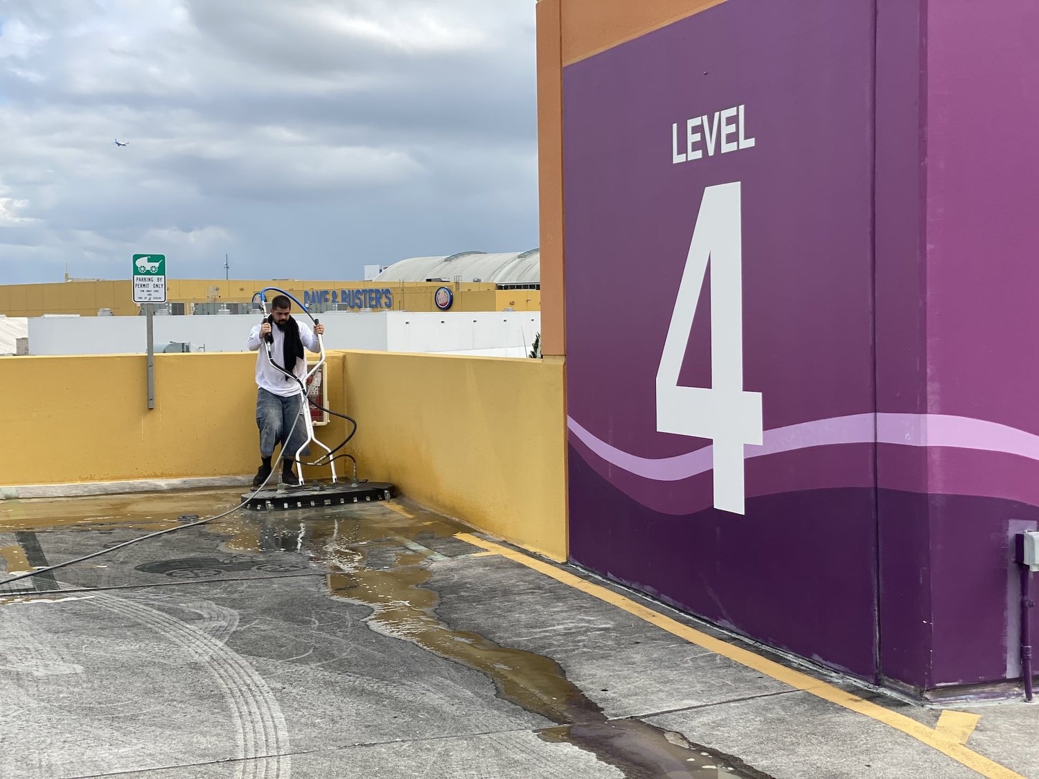 GWS crew pressure cleaning a level of a Miami parking garage